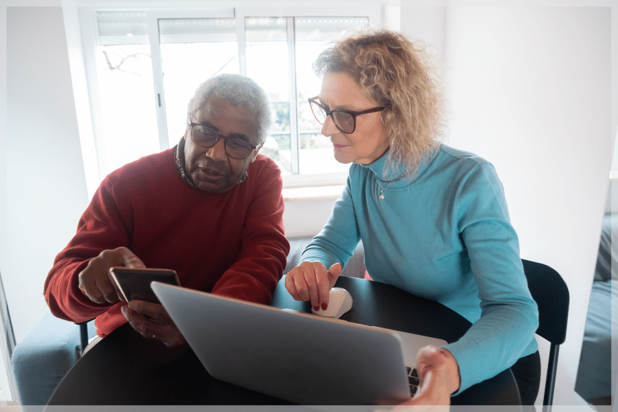 Aging in place products - Senior couple using smartphones and laptop - MeetCaregivers