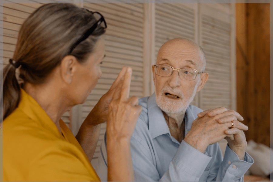 Caregiver training - Woman speaking to elderly man - MeetCaregivers