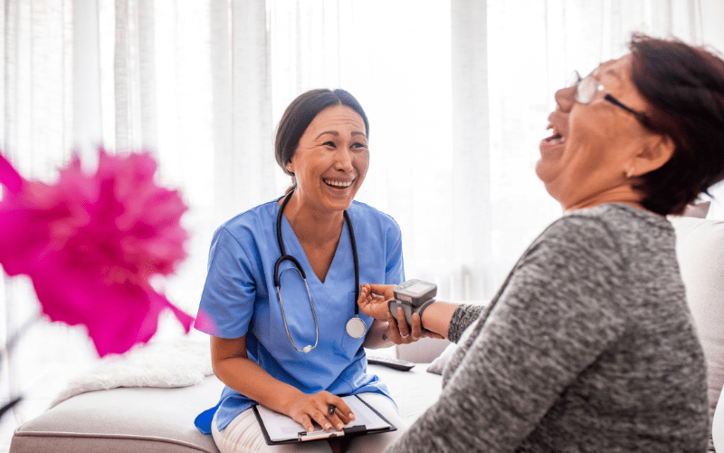 nurse taking laughing womans vitals