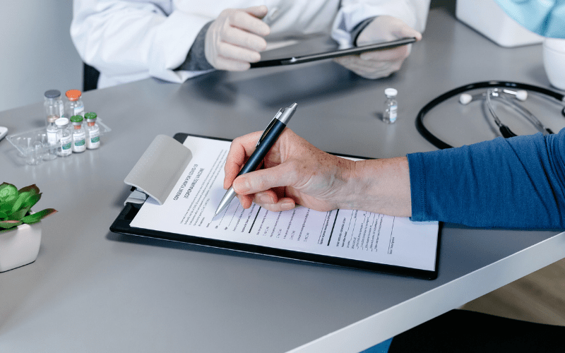 older man filling out vaccination form