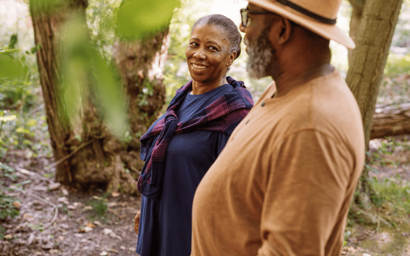 two-older-adults-on-a-nature-walk-enjoying-senior-living-in-massachusetts