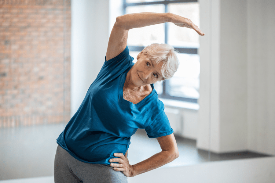 Older woman performing a sidebend stretch