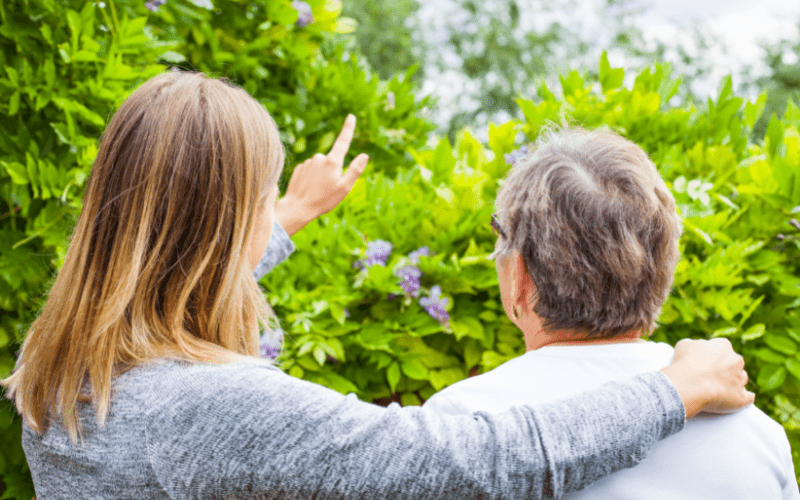 adult daughter and mother observing outside