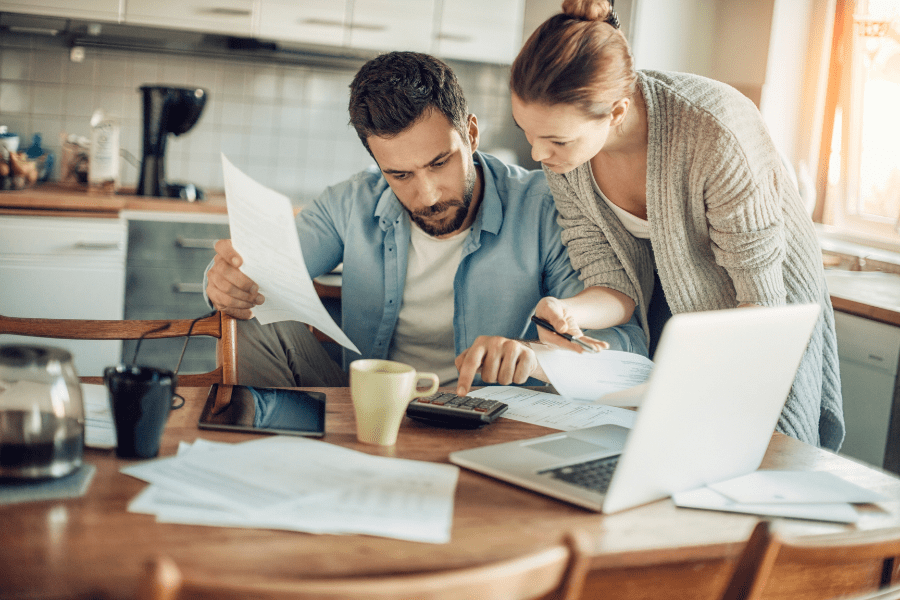 Young couple going over their finances together in the kitchen