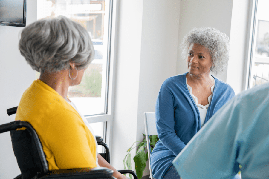 Two women talking in a senior support group.