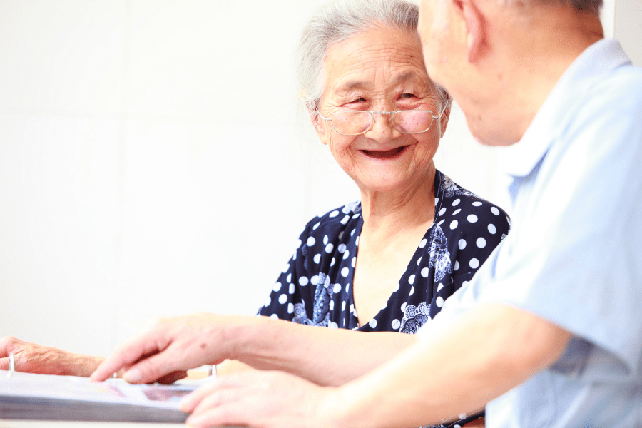 Happy elderly couple discussing end-of-life planning.