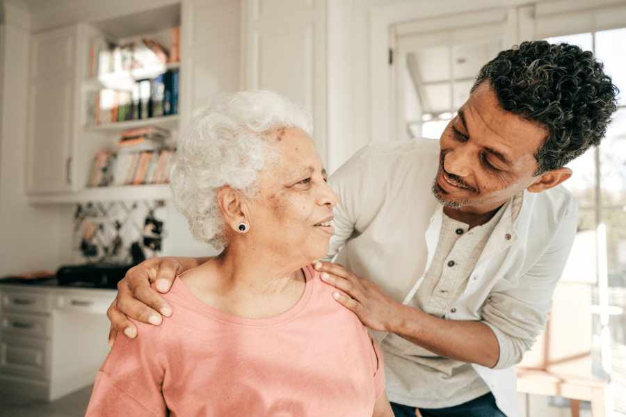 Medical Staffing Services - Adult Son Comforting His Elderly Mother At Home