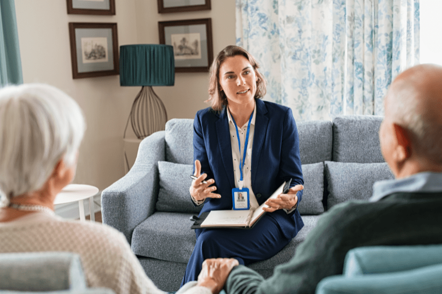 Home Care Professional Talking To Senior Couple About Long-Term Care Planning