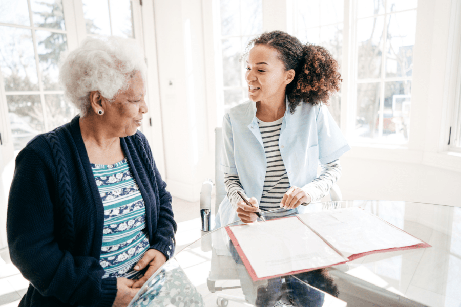 Home Care Professional Talking To Senior Woman About Long-Term Care Planning