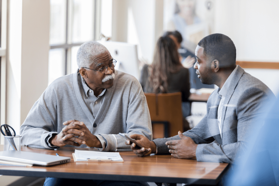 Older Man Talking To A Younger Man About Long-Term Care Planning
