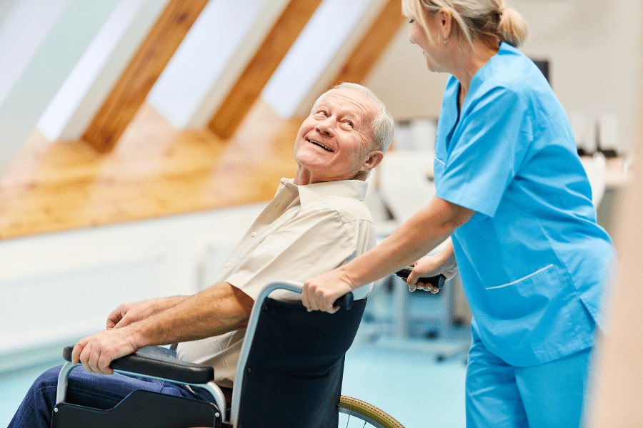 Nurse caring for a senior sitting in a wheelchair