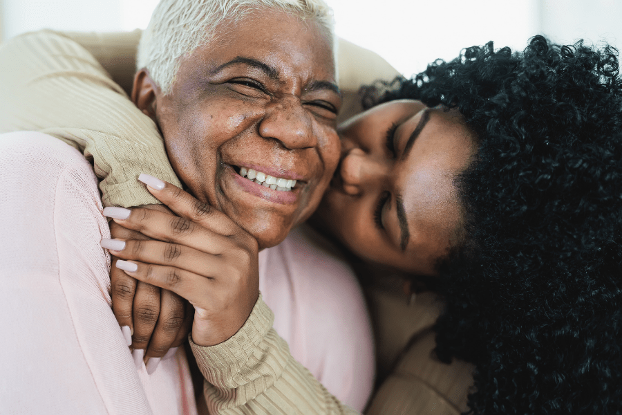 Mother and adult daughter sharing tender moment together