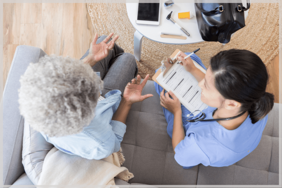 Balance and falling in the elderly - Home care nurse taking notes while talking to a female patient. - MeetCaregivers