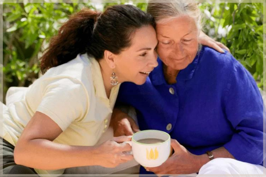 Caring for aging parents – Mother and daughter hugging outside – MeetCaregivers