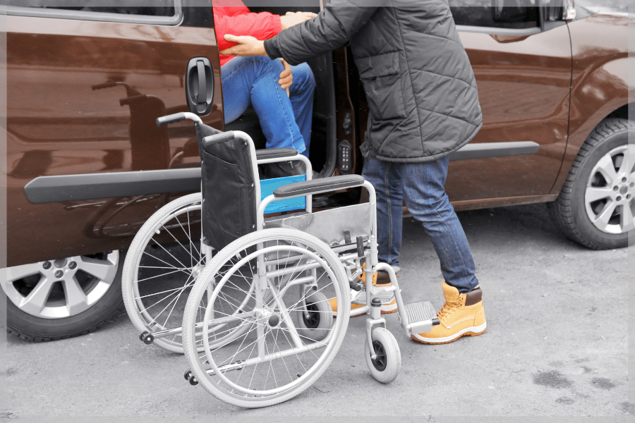 Reliable transportation - Caregiver helping senior person out of a van into a wheelchair - MeetCaregivers