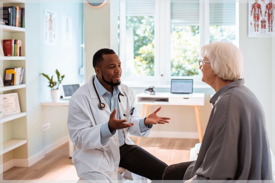 Cultural Competence - Doctor talking to elderly patient in his office - MeetCaregivers