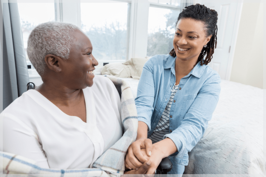 National Hospice and Palliative Care Month - Caring adult daughter comforts her aging mother - MeetCaregivers