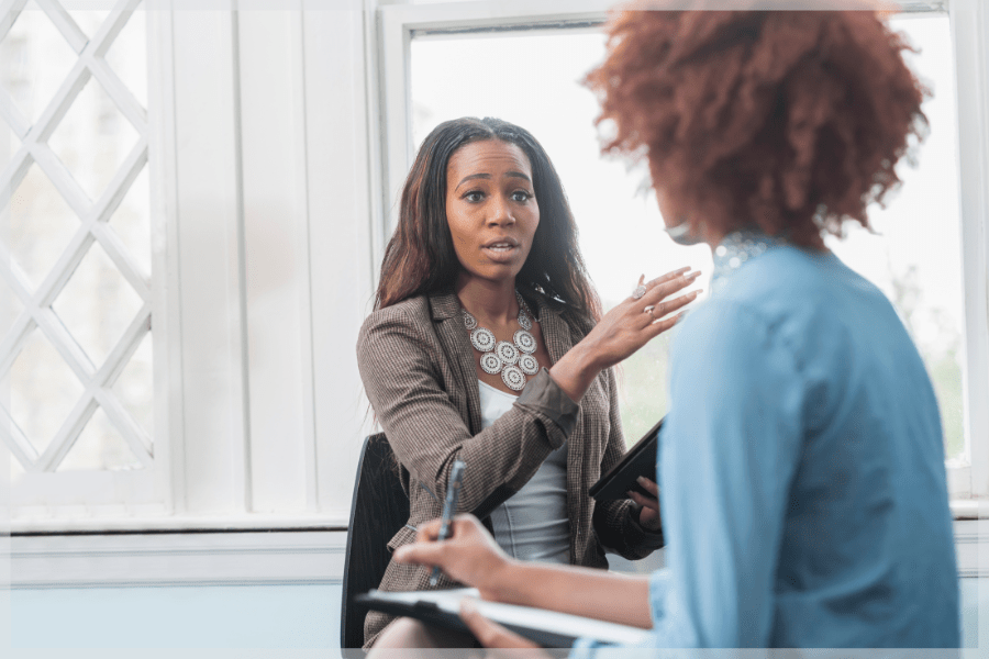 Caregiver Stress Syndrome - Woman talking to HR manager at work - MeetCaregivers
