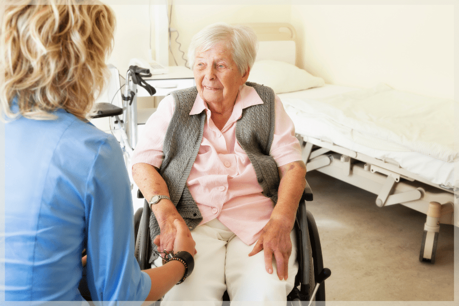 Hiring A Caregiver - Caregiver holding elderly woman's hand - MeetCaregivers