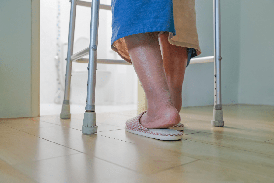 Home Modifications For Visual Impaired Seniors – Elderly Woman Using A Walker To Reach The Bathroom