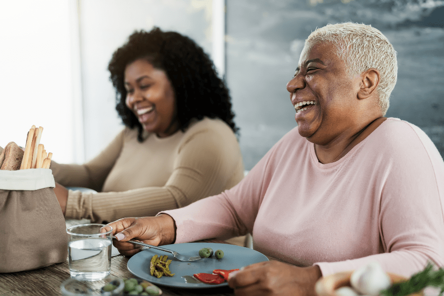 National Nutrition Month – Happy Mother and her daughter eating healthy lunch at home