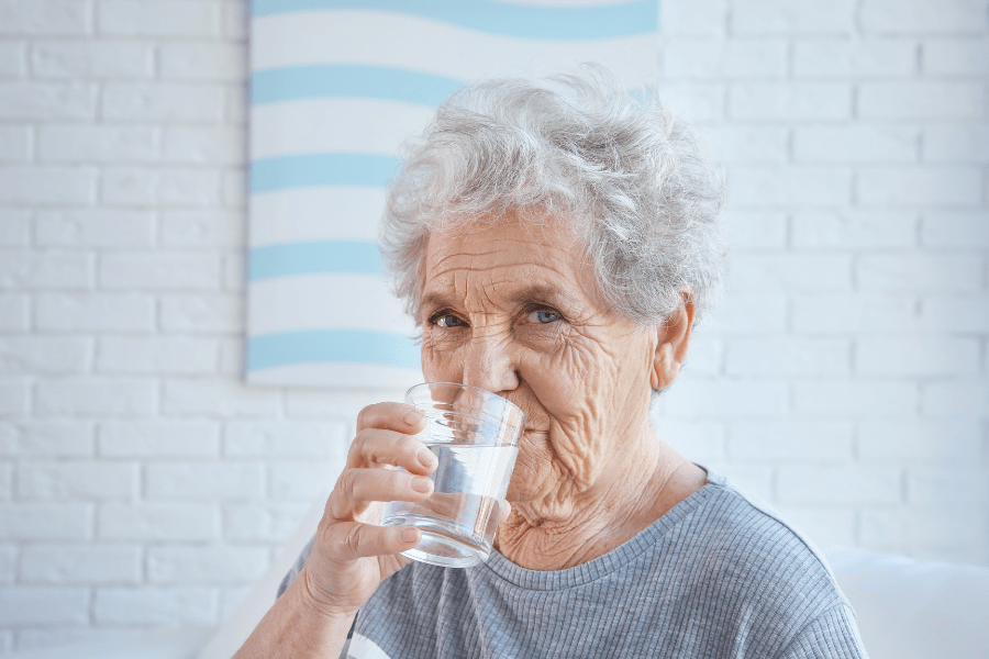 National Nutrition Month –Elderly woman drinking water at home
