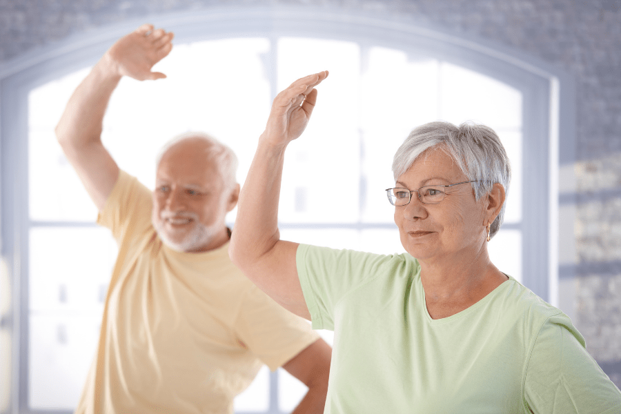 Older couple performing exercises to help ease balance problems in seniors