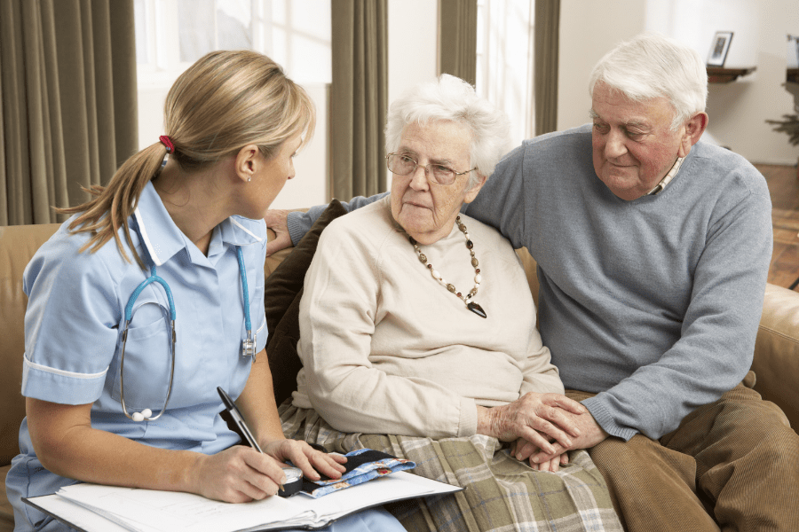Senior couple discussing respite care with a home health provider.